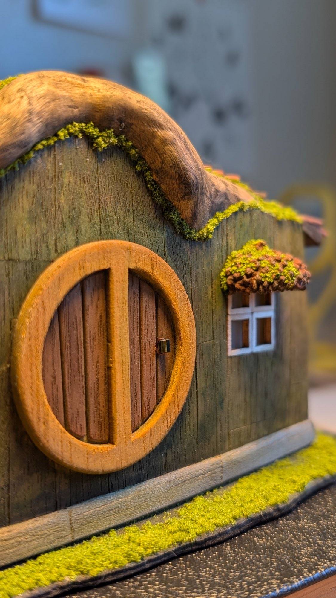 The round door close up, its frame sanded by hand with a brass pin for a handle