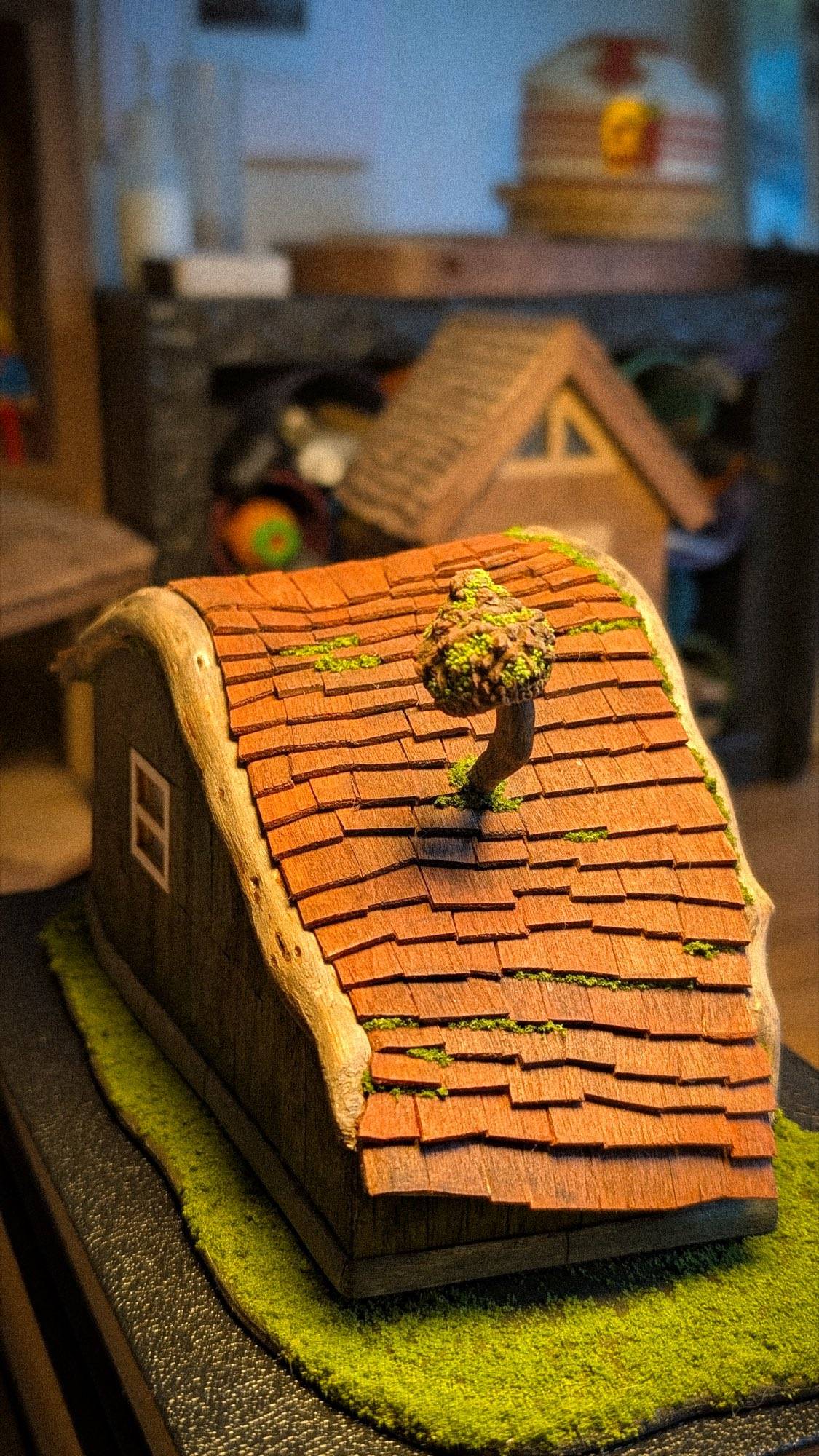 The ridge from above, tiles laid one at a time towards the chimney