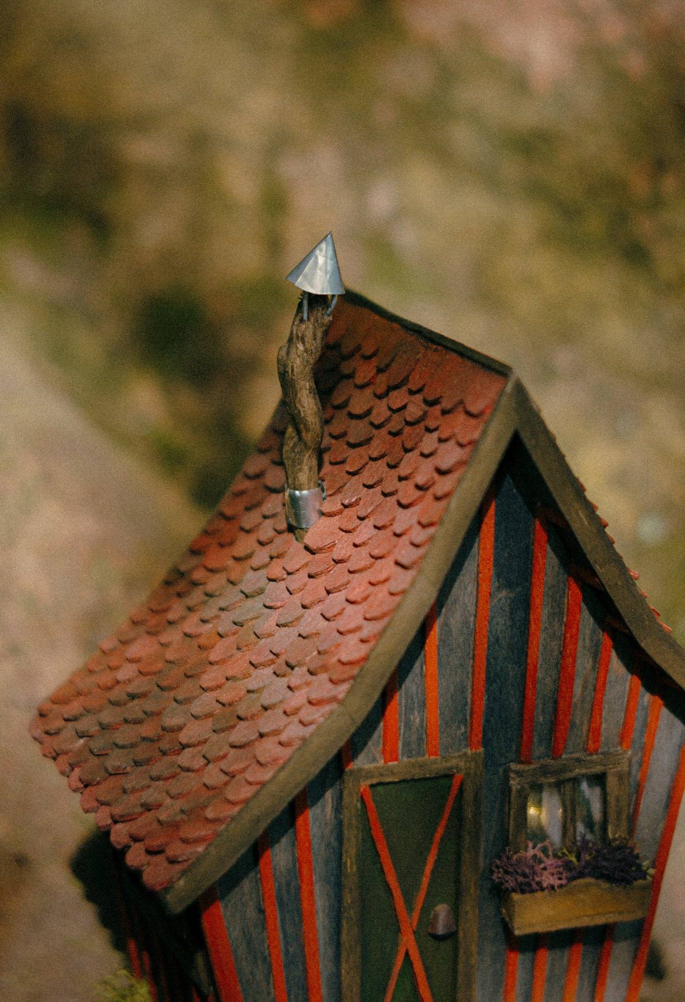 The roof close up, every clay-red tile cut and laid one at a time, with a window box of dried lavender below